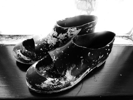 paint spattered shoes on woodの写真素材