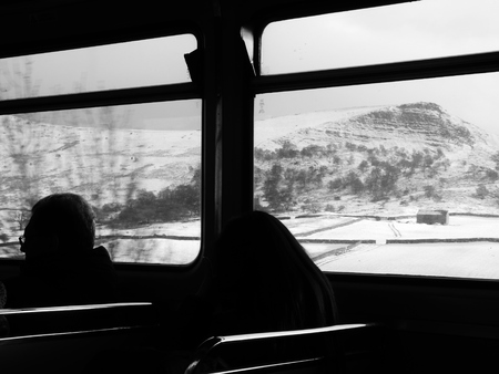 two people turned away train near mountainsの写真素材