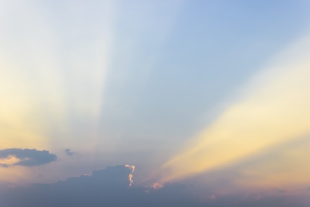 Sunset  clouds in formation to hide the sun and showing a beam of light の写真素材