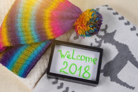 Welcome 2018. Christmas clothing style background knitted sweater, scarf, hat, mittens.の写真素材