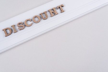 Word DISCOUNT abstract wooden letters, white background copy spaceの写真素材