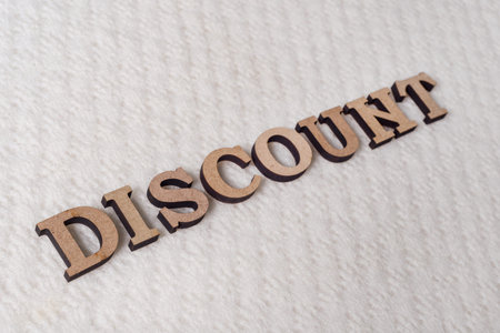 Word DISCOUNT abstract wooden letters, background textured winter light knitted woolen