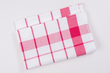 Background for product. Checked tablecloth in a red and white cage on white surface, view from above.の写真素材