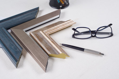Workplace of the artist, decorator, designer with samples of baguettes, frames