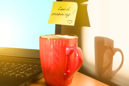 Sticker GOOD MORNING on laptop and breakfast. Autumn-winter backgroundの写真素材