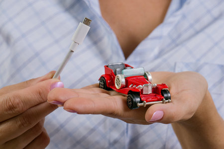 Electric car being plugged - EV transport concept