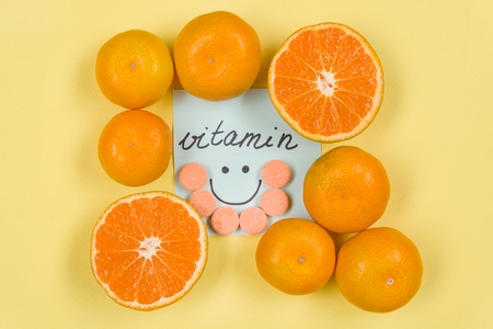 A Sticker with the word vitamin . Background yellow, vitamin C, citrusの写真素材