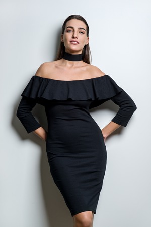 Attractive fashionable woman in black dress. White backgroundの写真素材