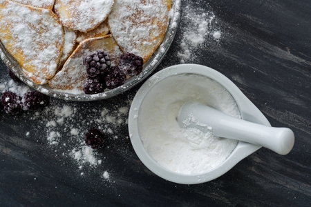 Homemade pancakes with blackberries, powdered sugar. Dark backgroundの写真素材