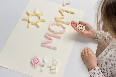 Mothers Day. The child makes a present for the mother. Spreads on the table card from the...