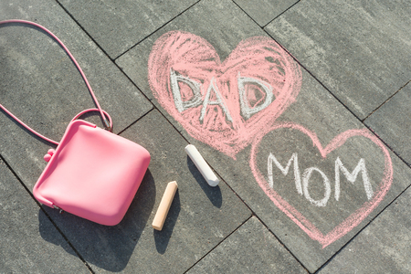 Children's drawing on asphalt text - Mom and Dad in heartの写真素材