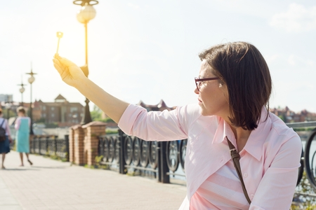 Woman in the street holds key in her hand.の写真素材