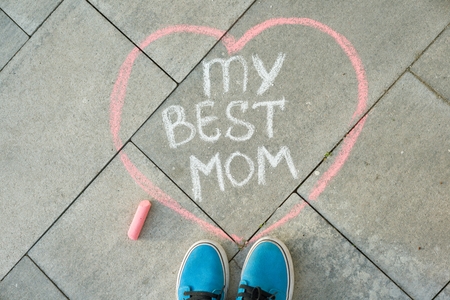 Mother's Day greeting card with handwritten text on the asphalt - my best mom heart and child feetの写真素材