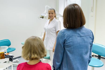 Mother and little daughter visiting pediatric dentist at dental clinics.の写真素材