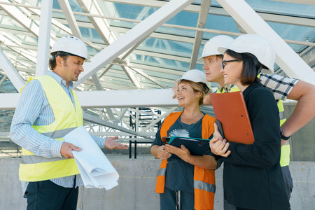 Group of engineers, builders, architects on the building site. Construction, development, teamwork...
