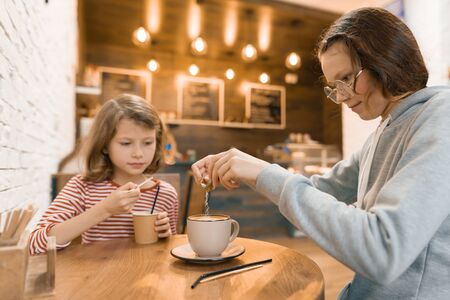 Two girls children in a cafe, drink milk drinks.の写真素材