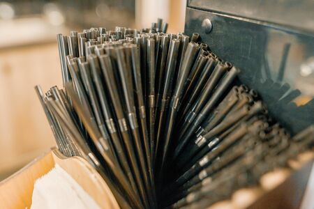 Lot of black plastic drinking straw, background cafe interior.の写真素材