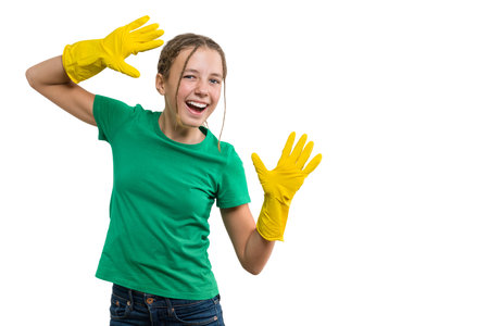 Young smiling cheerful girl in yellow rubber protective gloves, white isolated background.の写真素材
