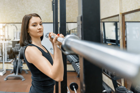 Young beautiful athletic woman brunette doing fitness exercises in the gym. Fitness, sport, training, people, healthy lifestyle conceptの写真素材