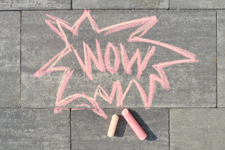 Wow written on gray sidewalk, top view.