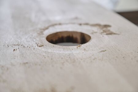 Closeup of making hole in wooden plank panel with woodworking electric tools, carpentry, woodwork, profession, people.の写真素材