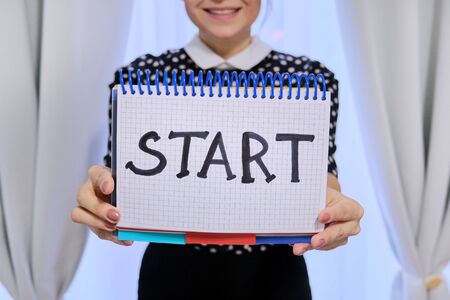 Woman holding notepad with hand written start word. Start of business, new year, relationship, studyの写真素材
