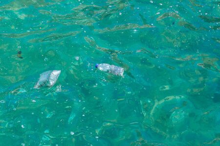 Garbage, trash plastic bottle packages on the sea ocean surfaceの写真素材