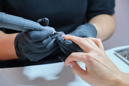 Woman doing manicure in the salon for care of hands and nails. Close up of manicure by professional...