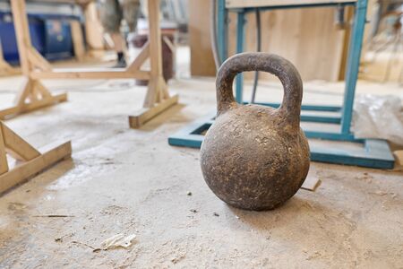 Background carpentry woodworking woodshop, heavy weight hand press for close-up on the floor.の写真素材