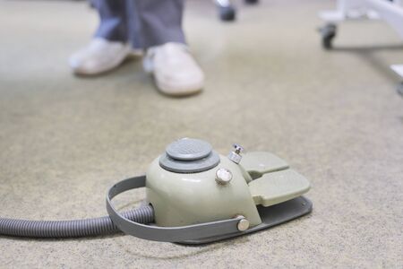 Dental chair foot pedal, close-up medical equipment in dentist office.の写真素材