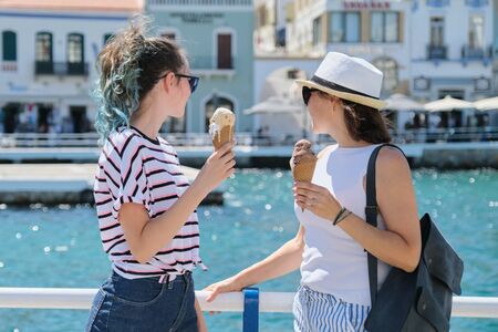 Europe tourist travel cruise vacation. Happy mother and daughter teenager with ice cream talking walking. Greece Mirabello Bay, Agios Nikolaosの写真素材