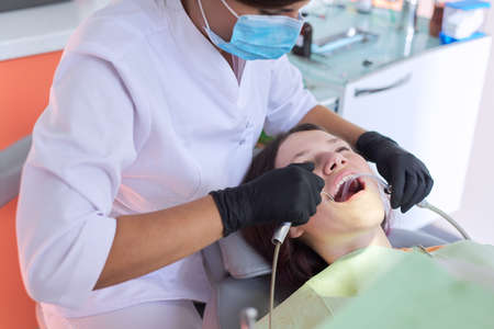 Teenager girl treating teeth at dentist office, consultation of orthodontist. Dentistry, healthy teeth, medicine and healthcare conceptの写真素材