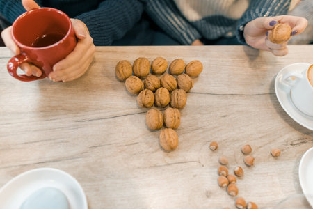 Winter background, walnuts in the form of a Christmas tree on the table, top view