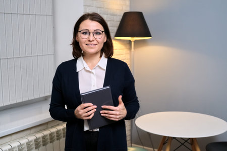 Portrait of confident business middle aged counselor woman, lawyer, advisor, secretary in office,...