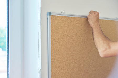 Installation of wall cork board for announcements, notes, advertisements