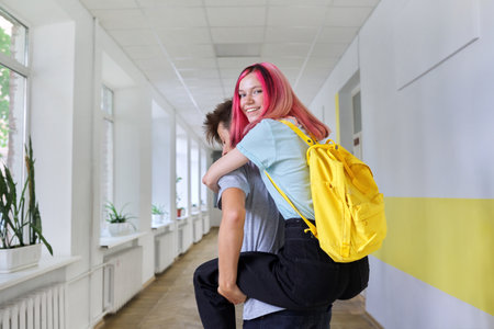 Teenagers boy and girl friends having fun at school. Teens, friendship, youth, school, college conceptの写真素材