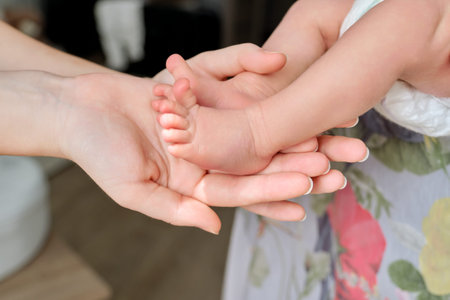 Newborn baby feet in moms hands. Infancy, motherhood, parenthood, love, family concept