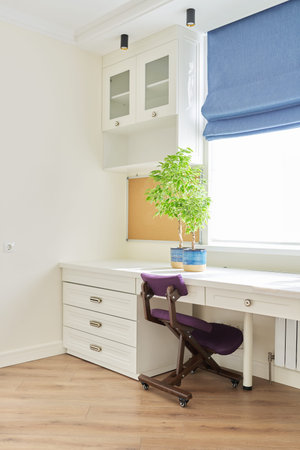 Orthopedic knee chair in the interior of childrens room, home office. Taking care of your back...