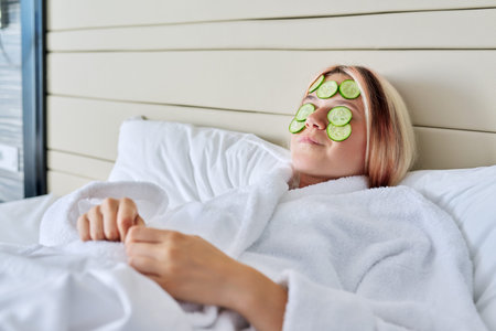 Young woman with natural cucumber face mask, skin care at a young age, relaxation, beauty, youth...