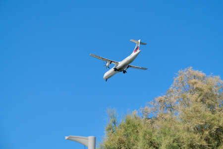 Greece Santorini, 11-09-2019. Sky Express, plane in the sky over greek famous tourist volcanic island Santorini. Air transport, tourism, travel conceptのeditorial素材