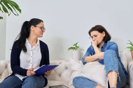 Midlife crisis, mature woman in consultation with psychologistの写真素材