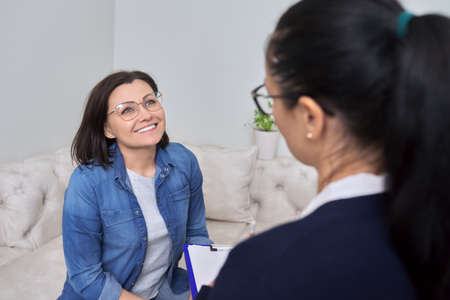 Middle-aged female at consultation of professional psychologistの写真素材