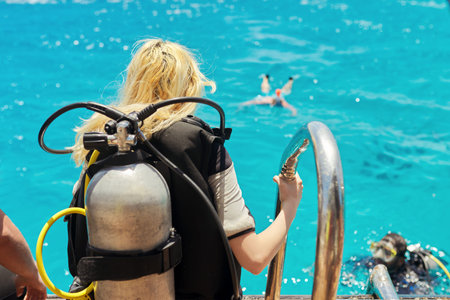 Young woman diver preparing for scuba divingの写真素材