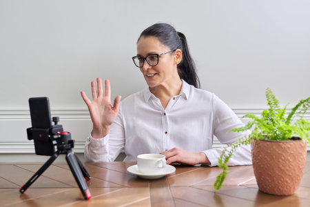 Young woman blogger vlogger recording broadcast at home