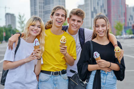 Group portrait of happy teenagers having fun with ice cream.の写真素材