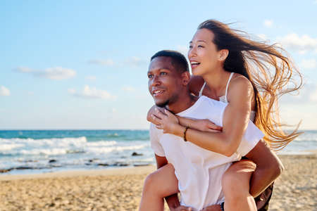 Young beautiful having fun couple on the sea backgroundの写真素材