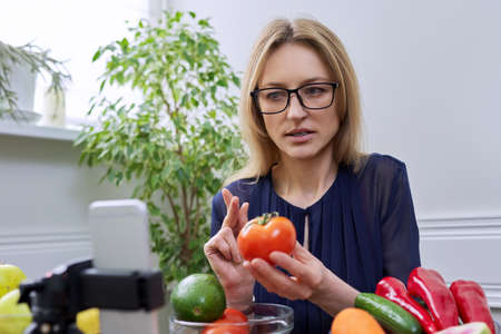 Woman nutritionist recording a video about healthy food, nutritionの写真素材