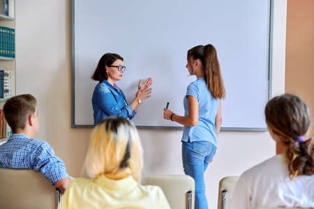 Lesson in classroom with digital screen for group of teenagersの写真素材