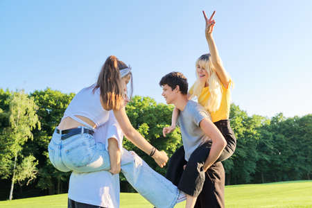 Teenage youth having fun in the park, happy laughing friends.の写真素材