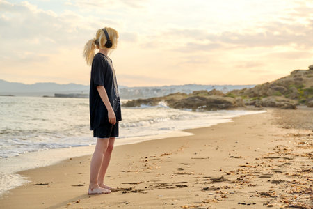 Young teenage female on the beach in the morning